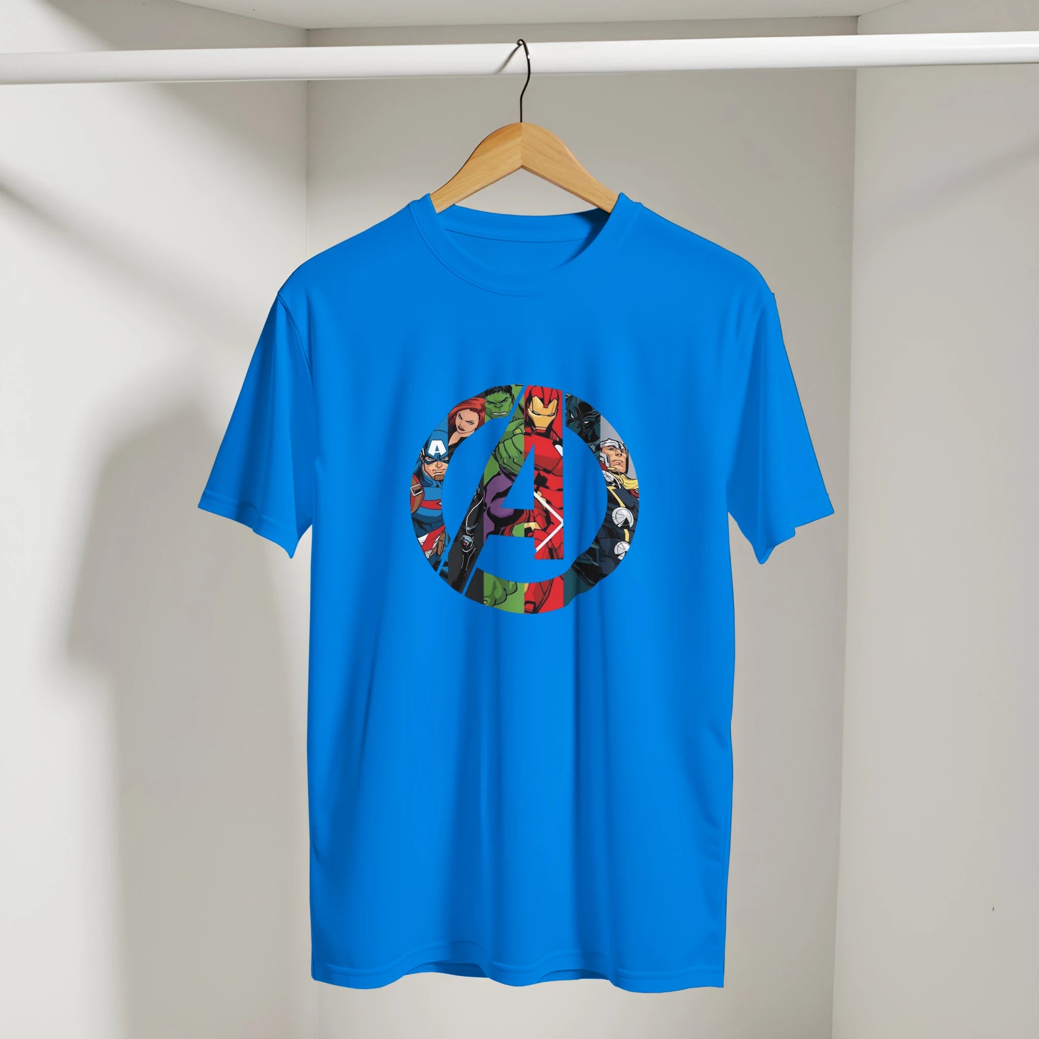 Blue t-shirt with superhero logo on a hanger against a white wall